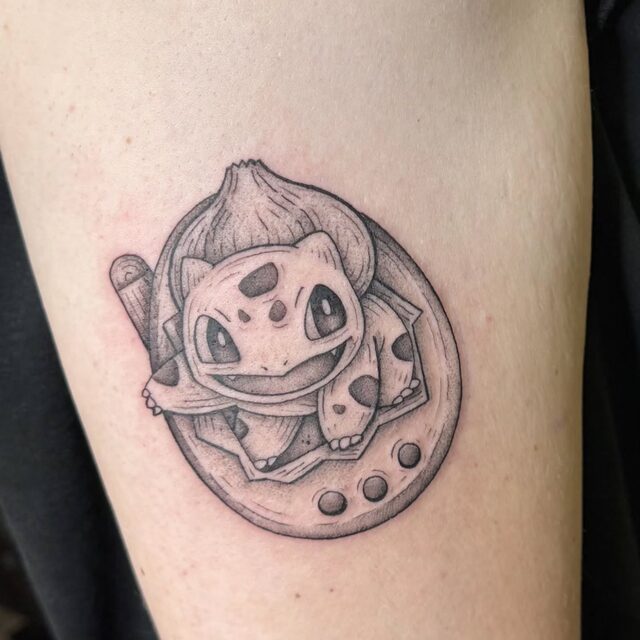 Bulbasaur sitting inside a lucky horseshoe in black and grey